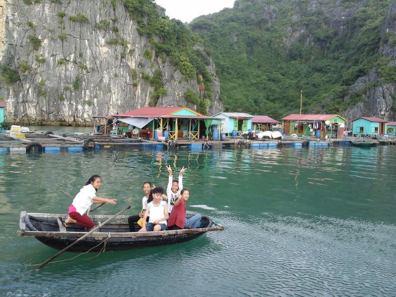 Children smiling happily on a boat